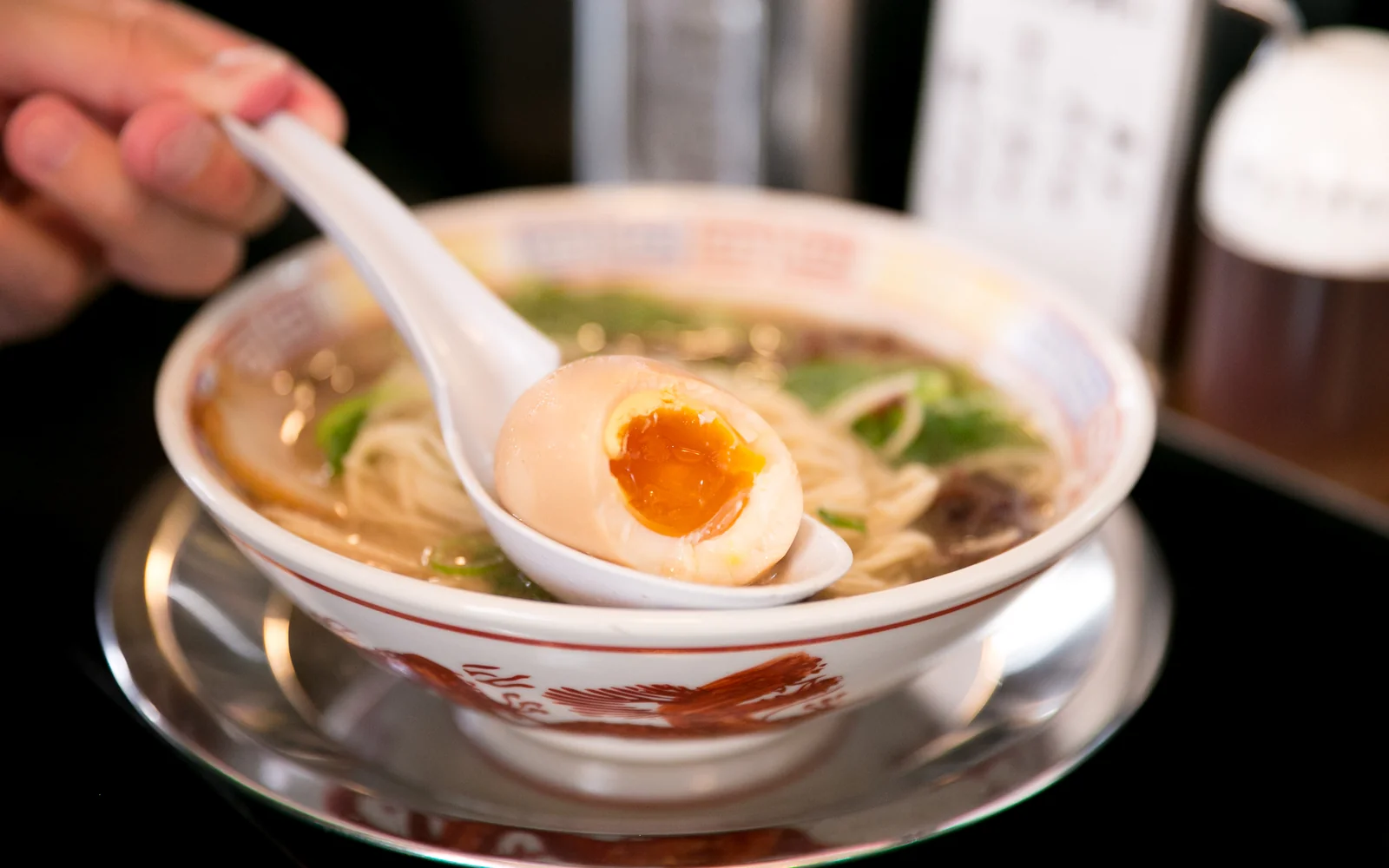 Creamy Hakata tonkotsu ramen bowl with sliced chashu, finely chopped scallions, and thin straight noodles