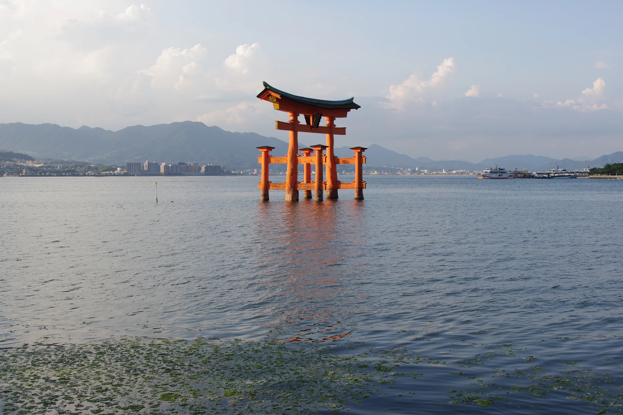 The iconic vermilion floating O-Torii gate of Itsukushima Shrine standing gracefully in the tidal waters of Miyajima