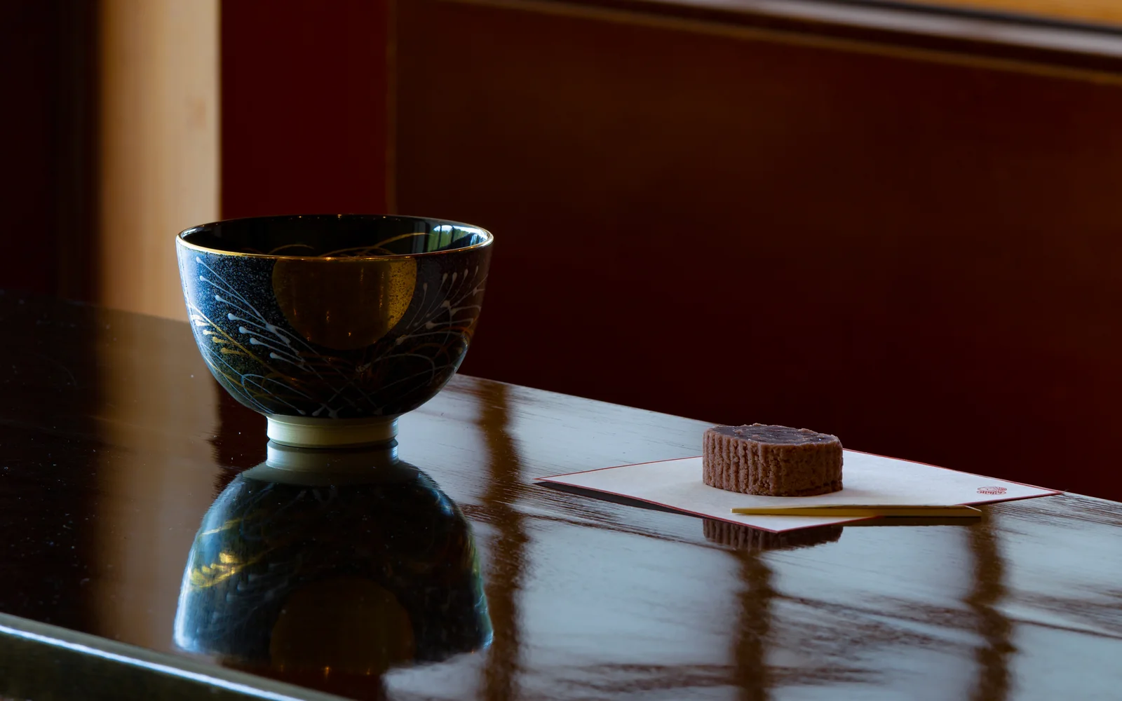 Artisanal seasonal Wagashi namagashi paired with freshly whisked Uji matcha chawan in Japanese tea ceremony setting